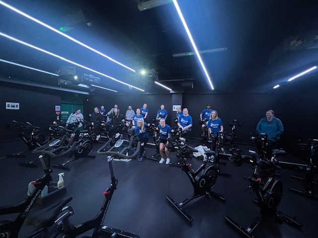 Photo of staff members on excercise bikes